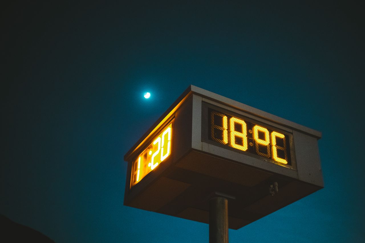 Services A digital clock shows time and temperature against a night sky with a visible moon.